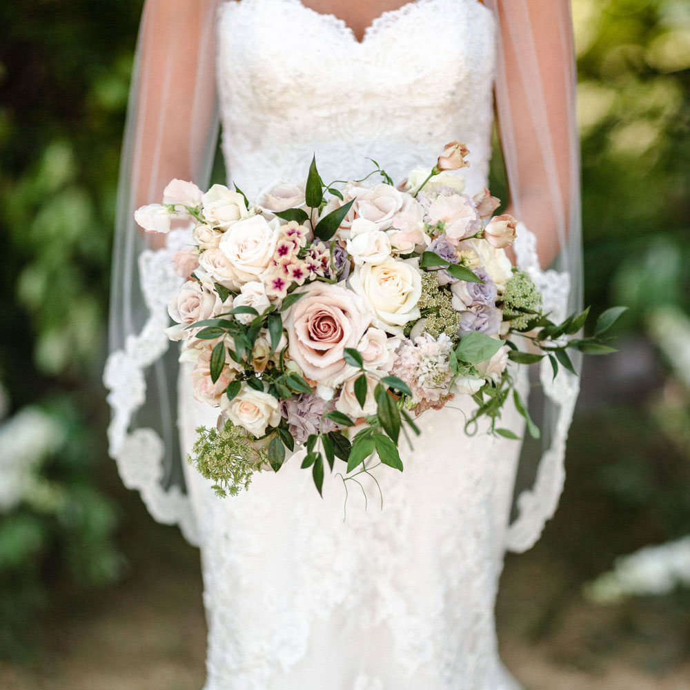 Romantic bouquets with lots of soft, seasonal blooms for this dream wedding.