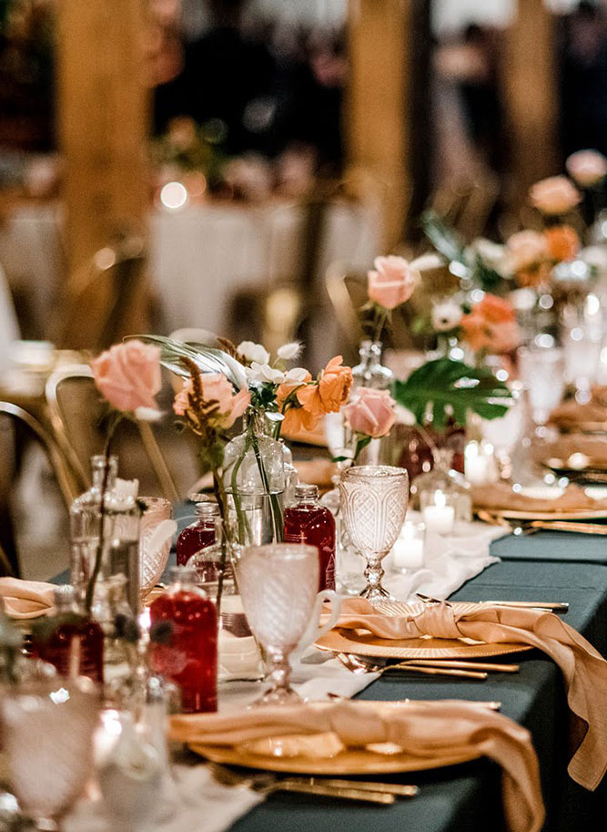 Close up of table setting at industrial wedding venue with soft florals.